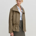 Sully Leather Jacket by Herskind ApS in olive green lamb leather with an oversized funnel neck and a smocked, elasticized waist.