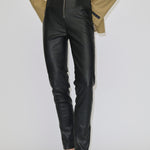 Person wearing black Barbie Leather Leggings with a front zipper and a tan blazer.