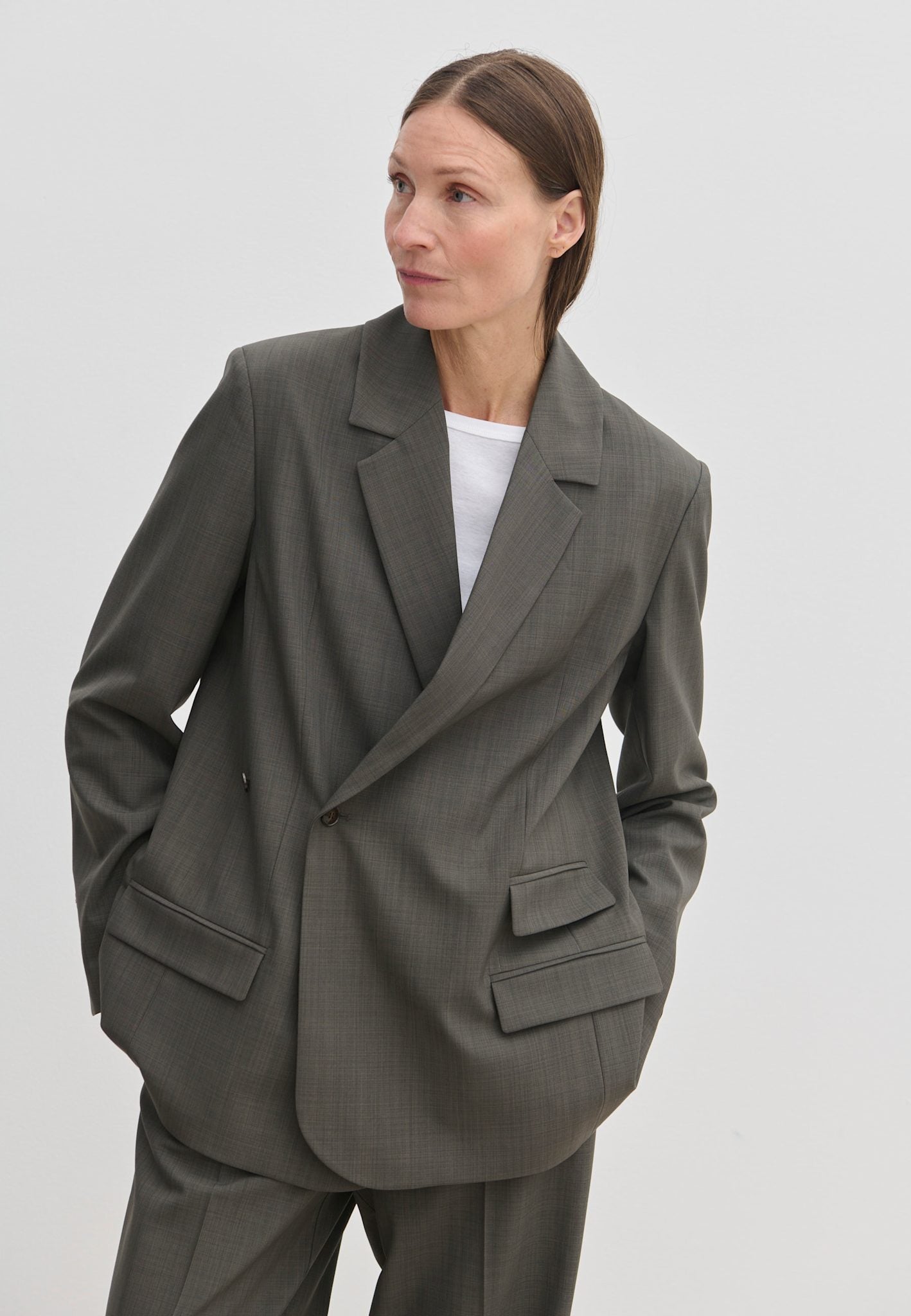 A person wearing a grey Amalfi Regular Blazer with structured shoulders over a white crew-neck t-shirt.