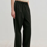Davi Mid waist Pants by Herskind ApS in black with a white side stripe and a comfortable elasticated waistband.