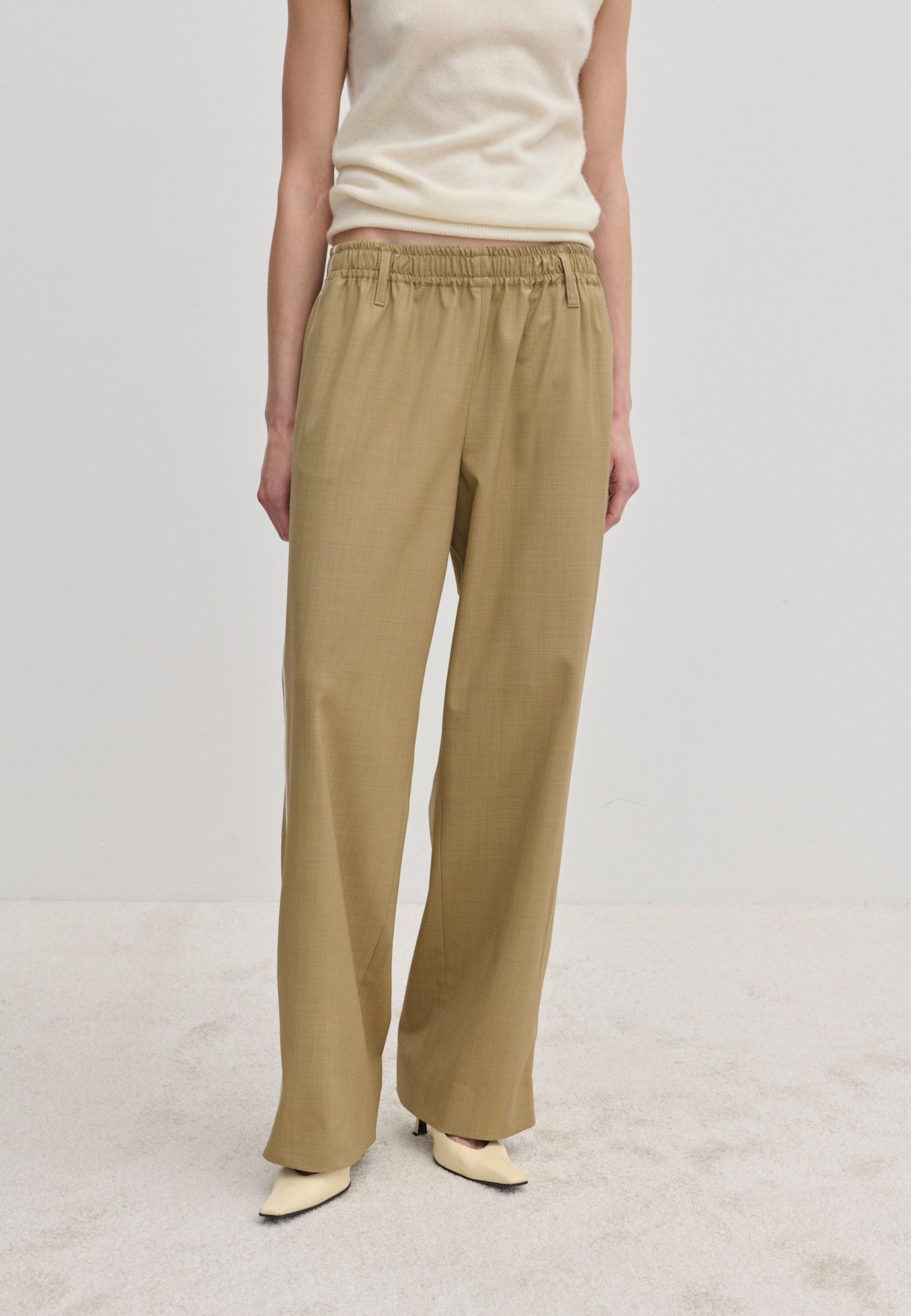 Beige Davi Mid waist Pants featuring an elasticated waistband and a wide-leg, straight-fit silhouette.