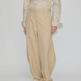 Beige mid-waist barrel leg Dante Mid Waist Pants with a relaxed fit, worn with a button-down shirt.