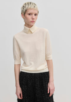 Cream-colored Perry Knit Blouse by Herskind ApS, featuring short sleeves and a pointed collar in merino wool.