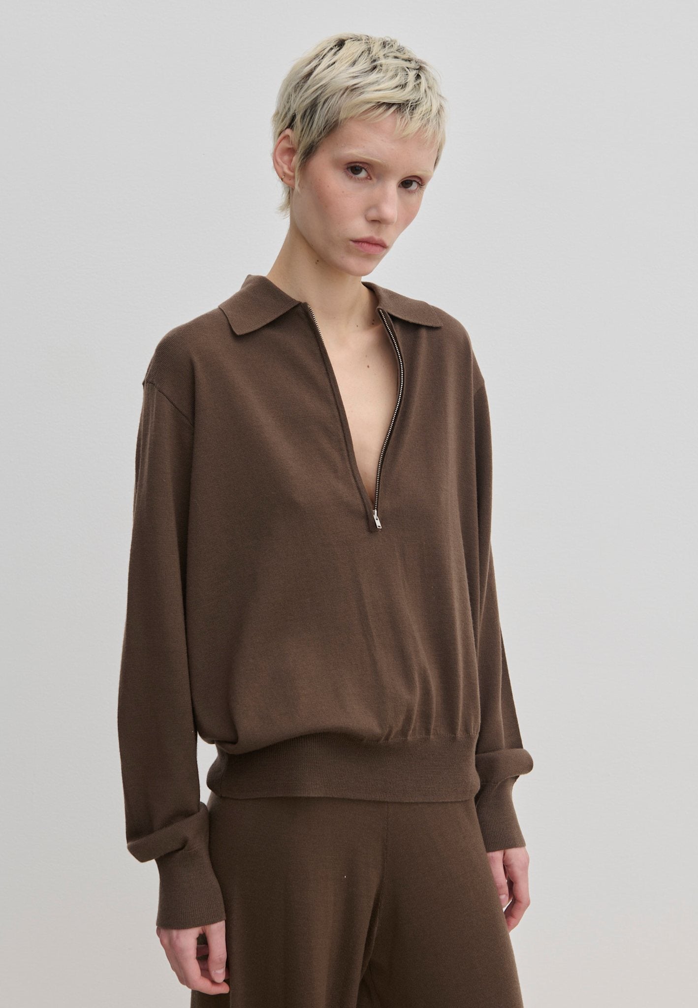 Agatha Knit Blouse by Herskind ApS in a brown fine-gauge knit with a polo collar and a front zipper.