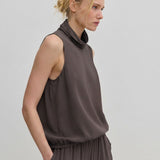 The Herskind ApS Loa Top is a sleeveless, brown FSC viscose top featuring a high, draped cowl neckline and a gathered hem.