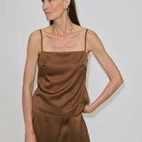 A model wears the brown Angela Top by Herskind ApS, featuring a square neckline and adjustable spaghetti straps.