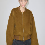 A model wearing the Herskind ApS Monica Bomber Jacket, a cropped wool and alpaca design with a zip-up front and a ribbed collar and waistband.