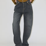 Dark grey, relaxed-fit wide-leg Antonie Denim Jeans (32 - Long) by Herskind ApS, worn with a high waist, an olive brown zip-up jacket, and pointed-toe boots.